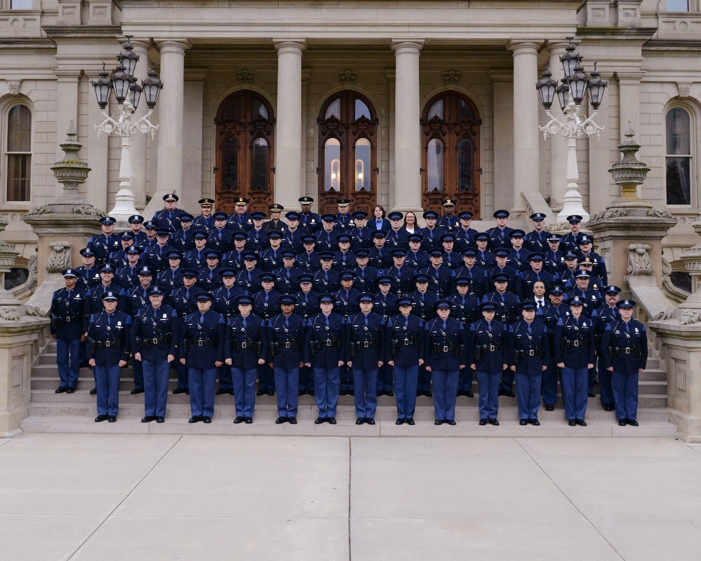 149th Trooper Recruit School graduates standing on the Capitol steps with Training Academy staff and Leadership Team members