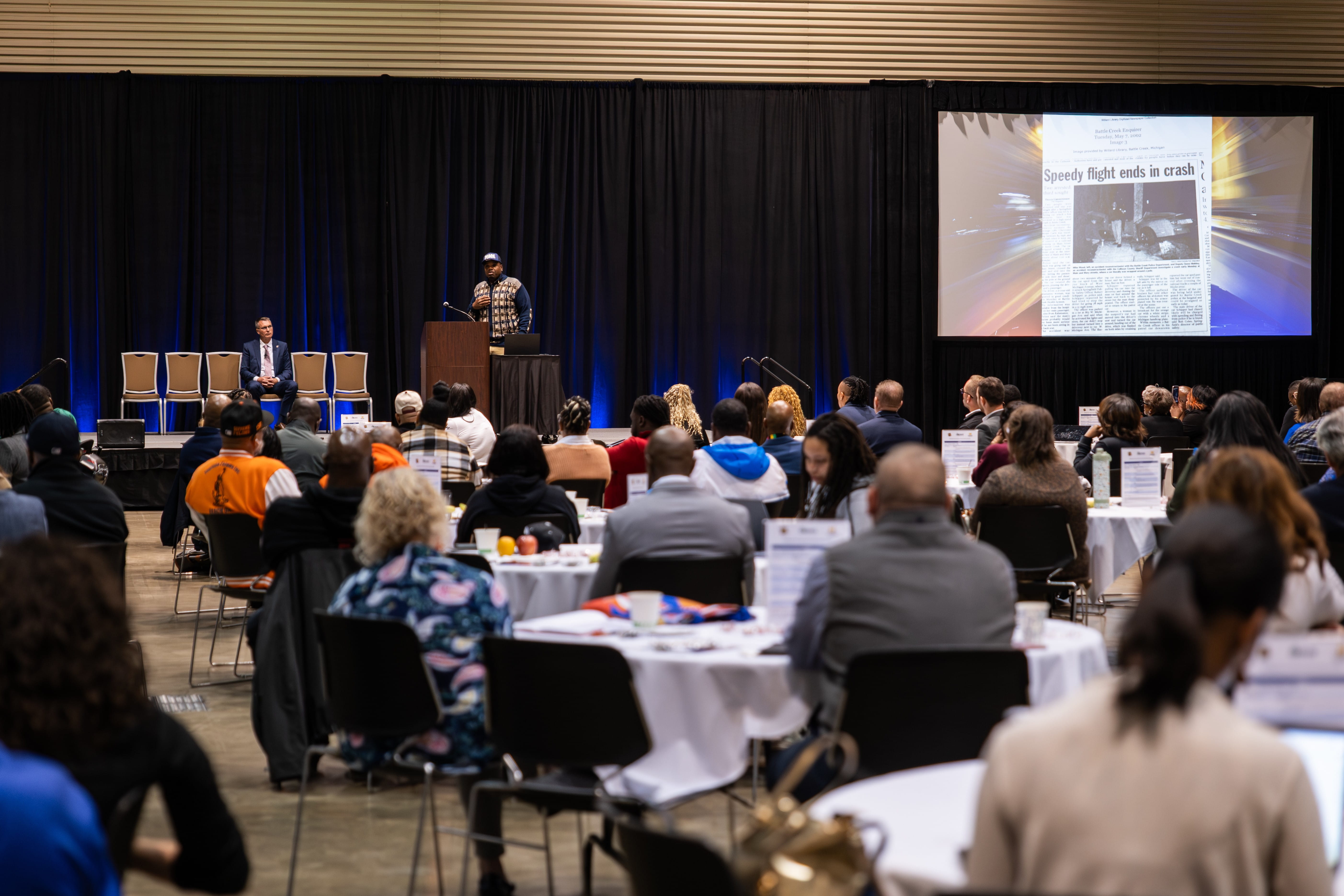 Presenter speaking to a crowd of people at the Gun Violence Intervention Summit