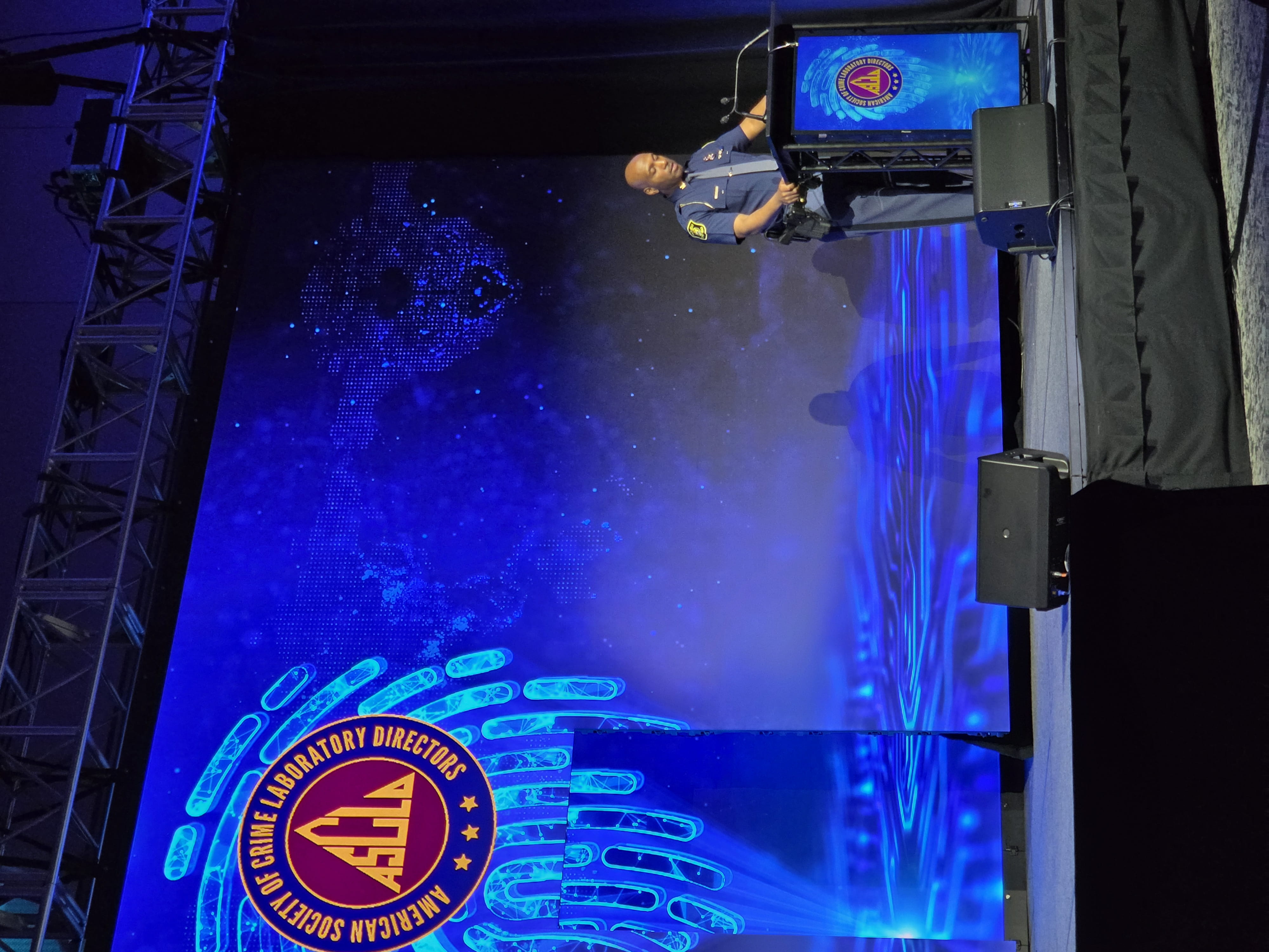 Colonel James F. Grady II, director of the MSP standing on stage at a podium giving opening remarks