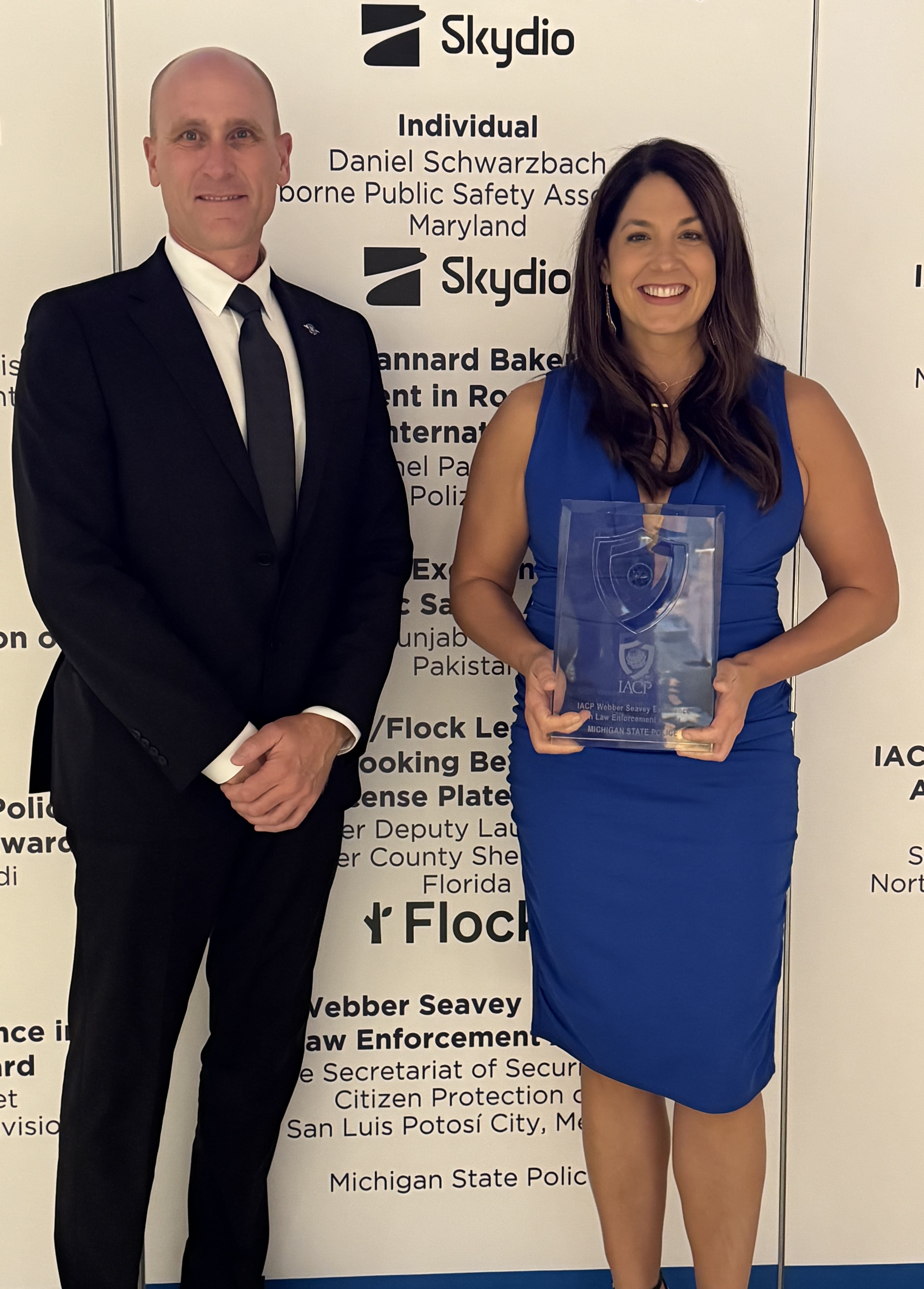Inspector Mike Bush, Assistant Commander, Seventh District standing with Specialist Lieutenant Ashley Miller was had just accepted an award