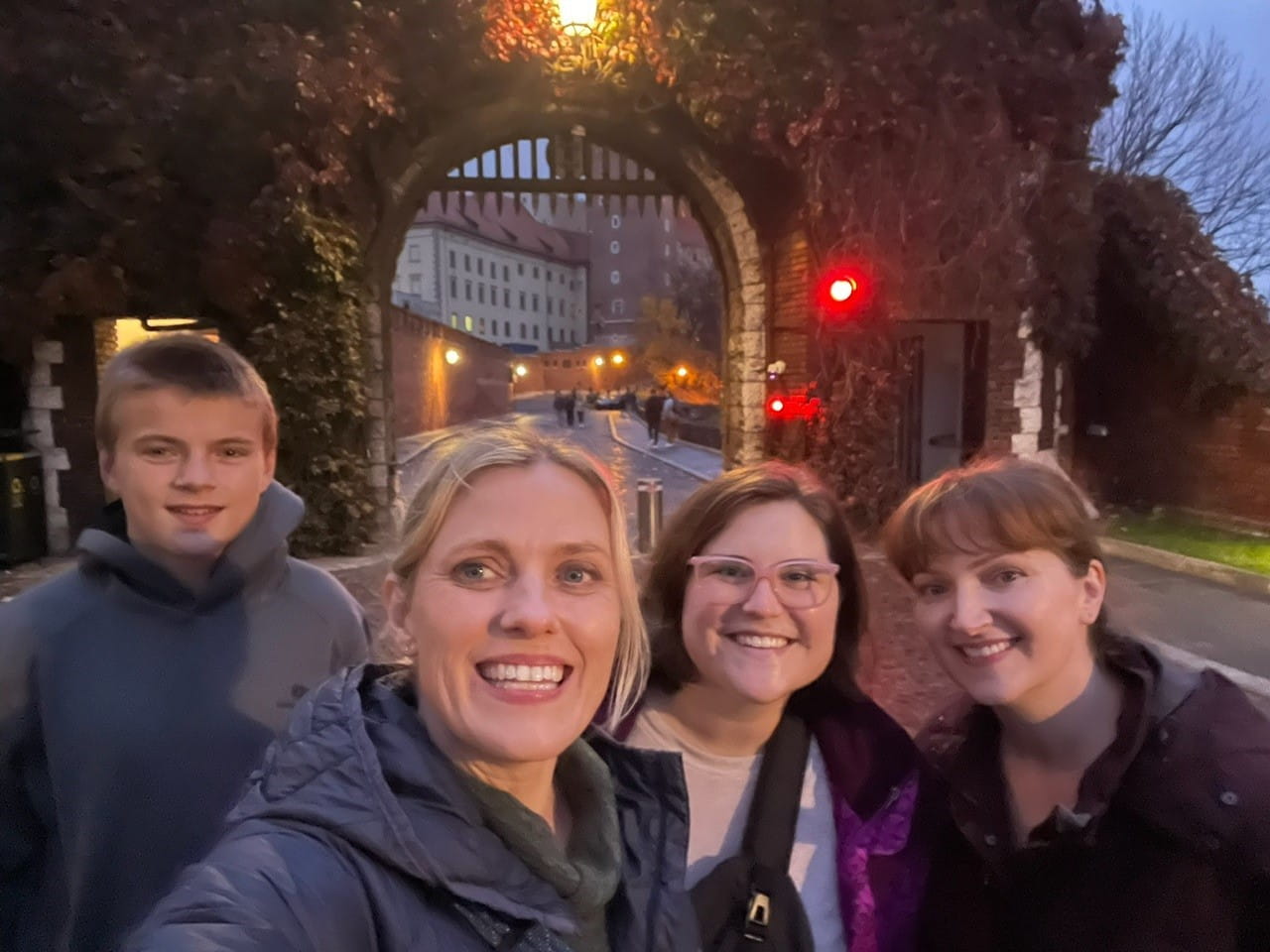 A group of people standing outside at night 