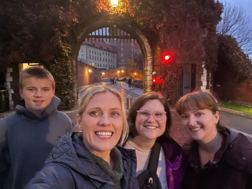 A group of people standing outside at night