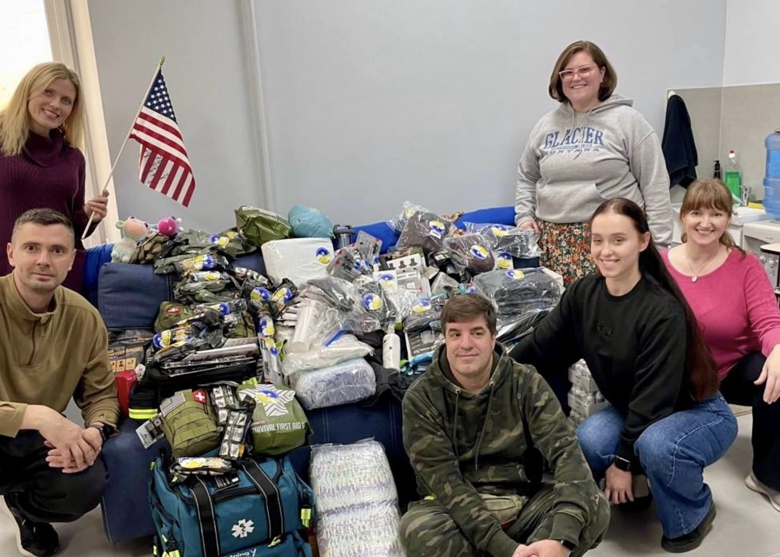 A group of people near a table of donated items