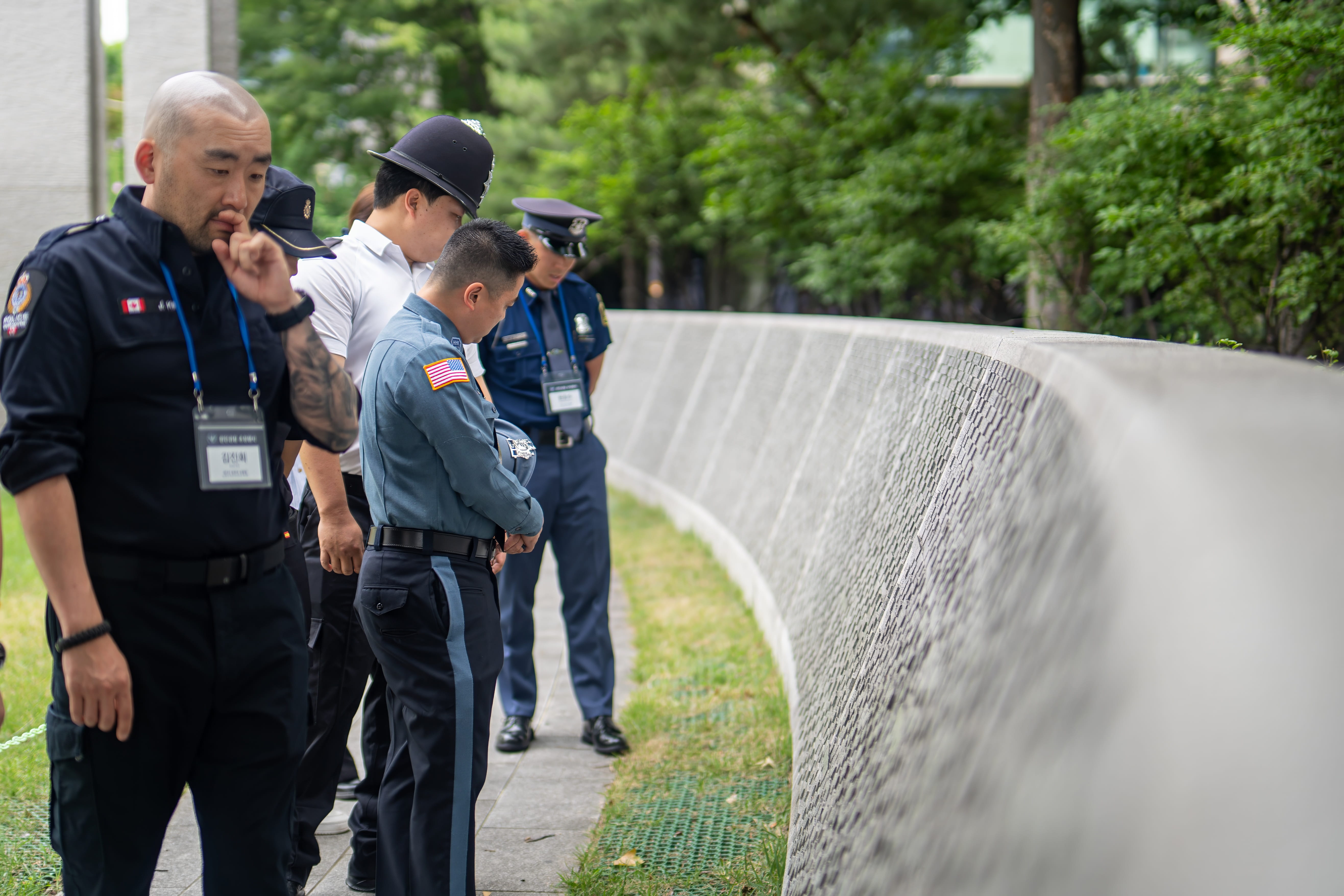 Police officers standing and looking at a wall in Korea