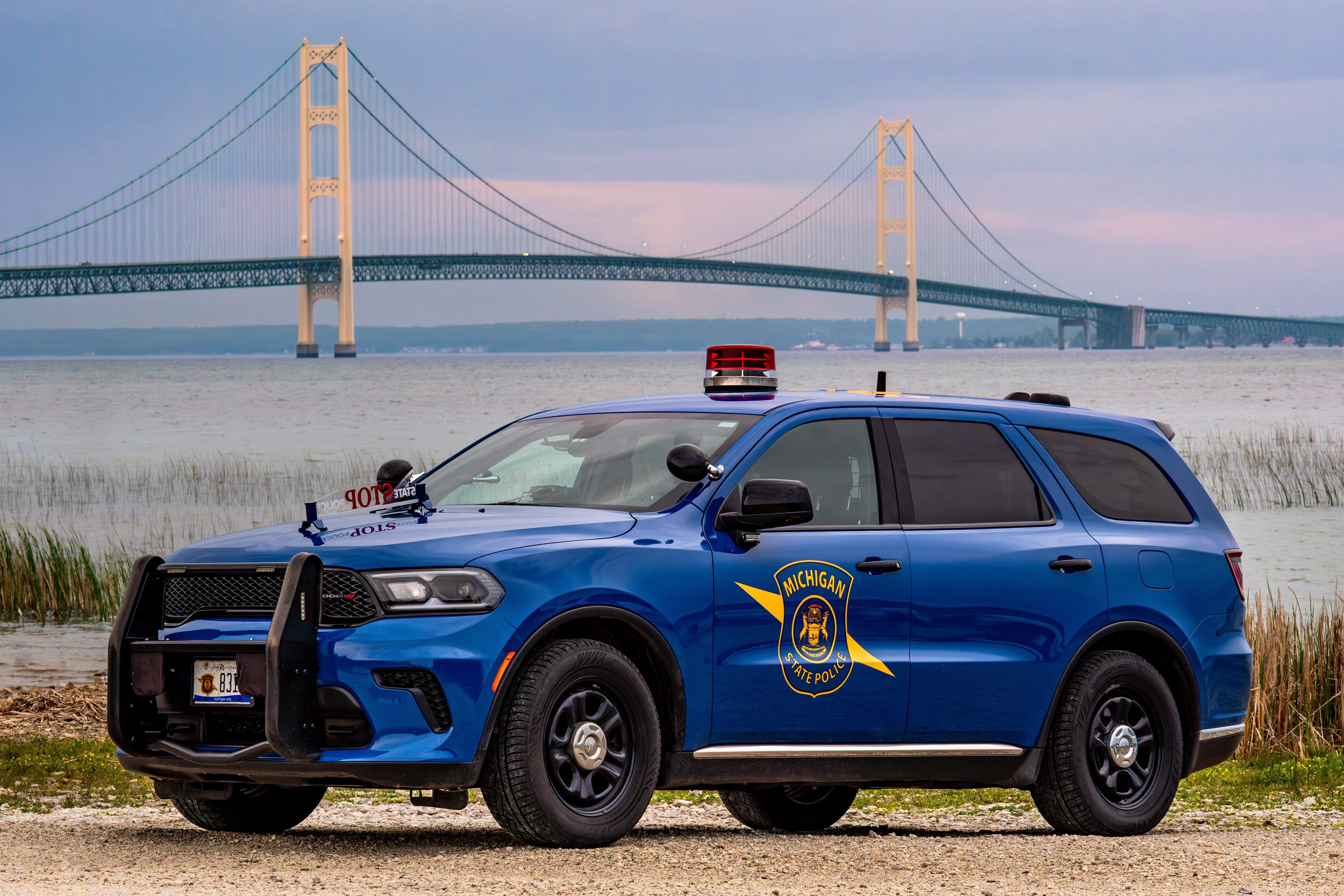 MSP’s 2024 Dodge Durango patrol vehicle photographed at an iconic Michigan landmark, the Mackinac Bridge and the Straits of Mackinac