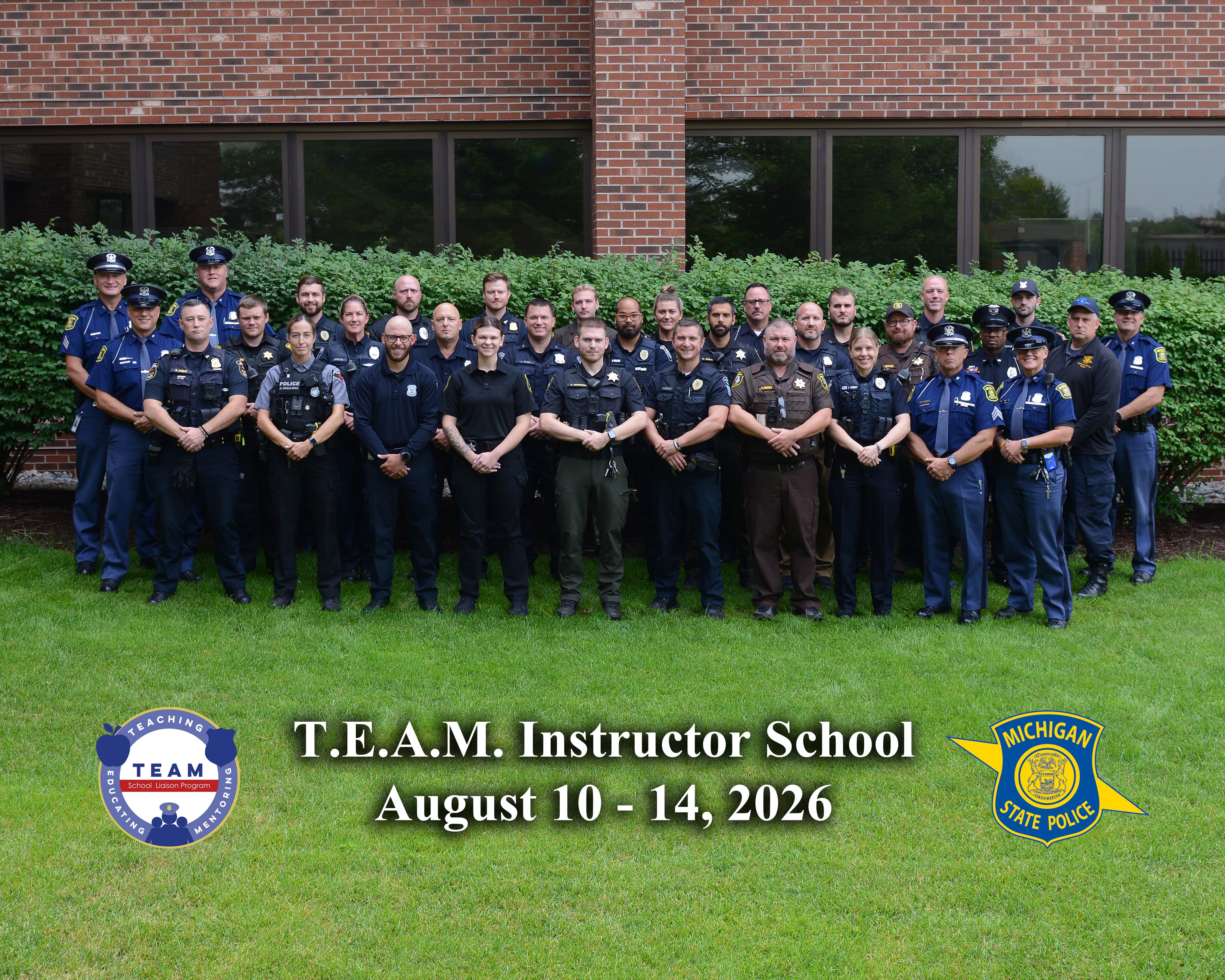 Graduating members of the August 2026 Teaching, Educating, and Mentoring (TEAM) School Liaison Program standing in a group outside of MSP Headquarters