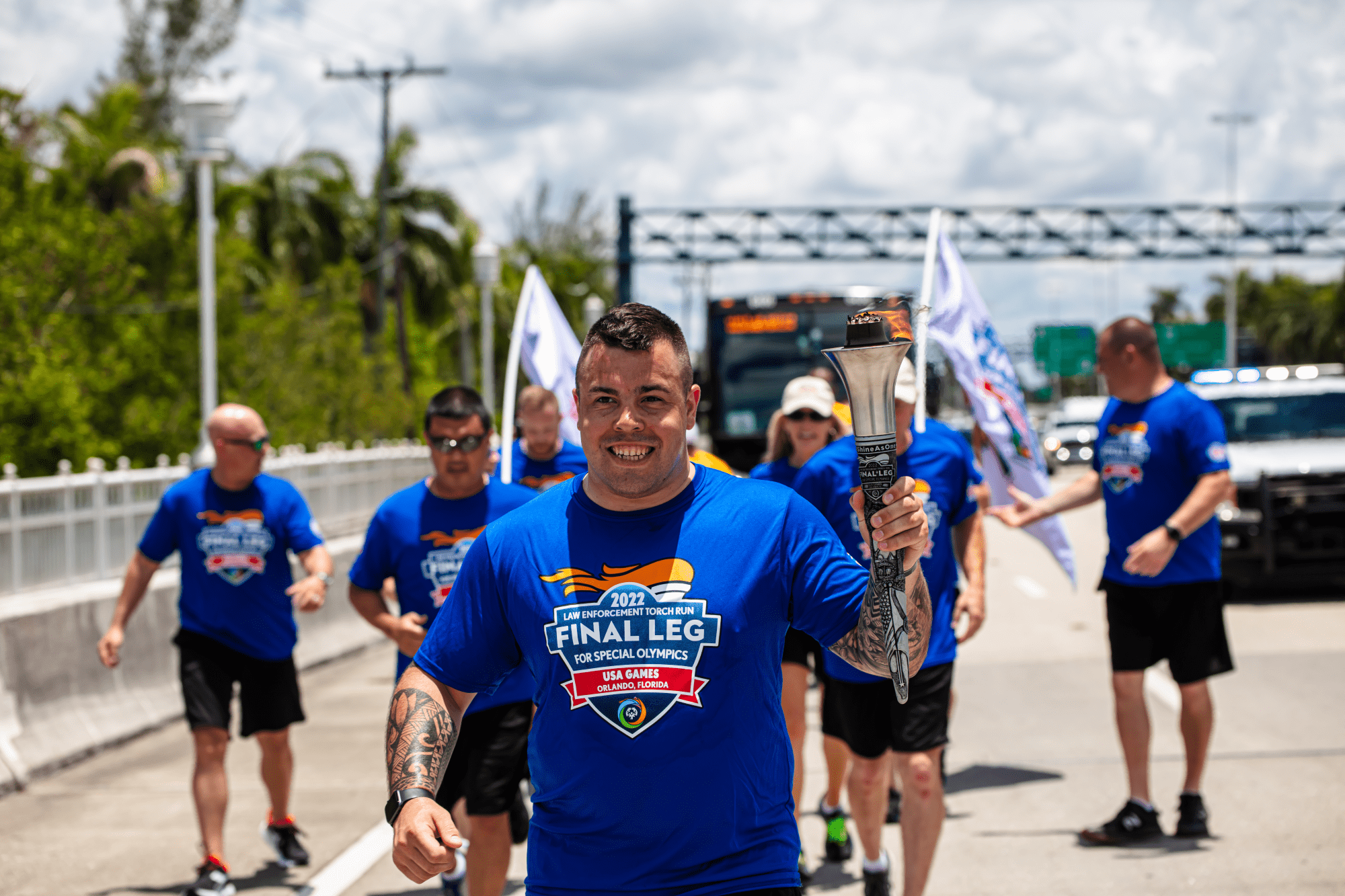 Michigan State Police Trooper Jacob Lewis running and carrying the Flame of Hope