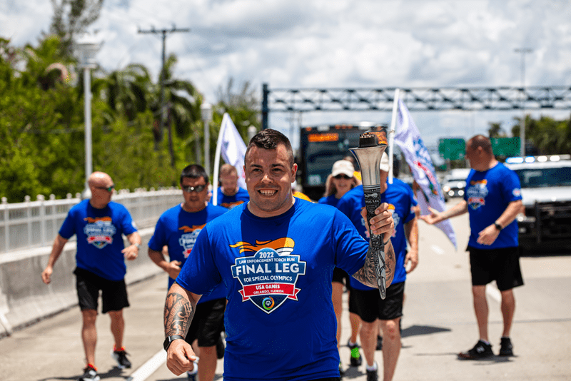 Michigan State Police Trooper Jacob Lewis running and carrying the Flame of Hope
