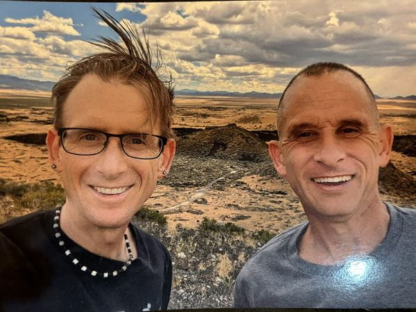 Photo of Tom and Kevin Sweeney in Utah standing in front of mountains