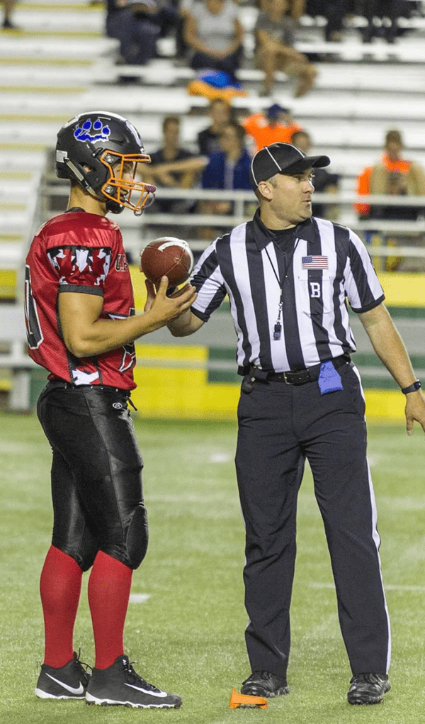 Photo of Lieutenant Mark Giannunzio officiating a football game