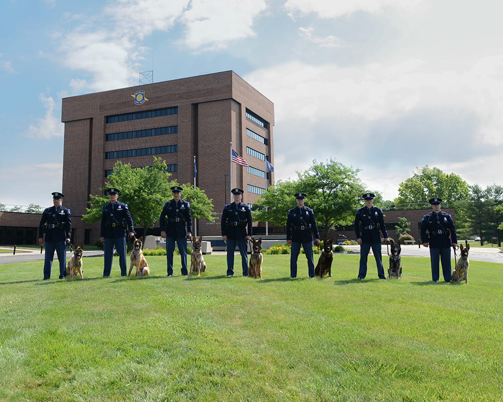 MSP handlers and canine partners standing outside of the Training Academy