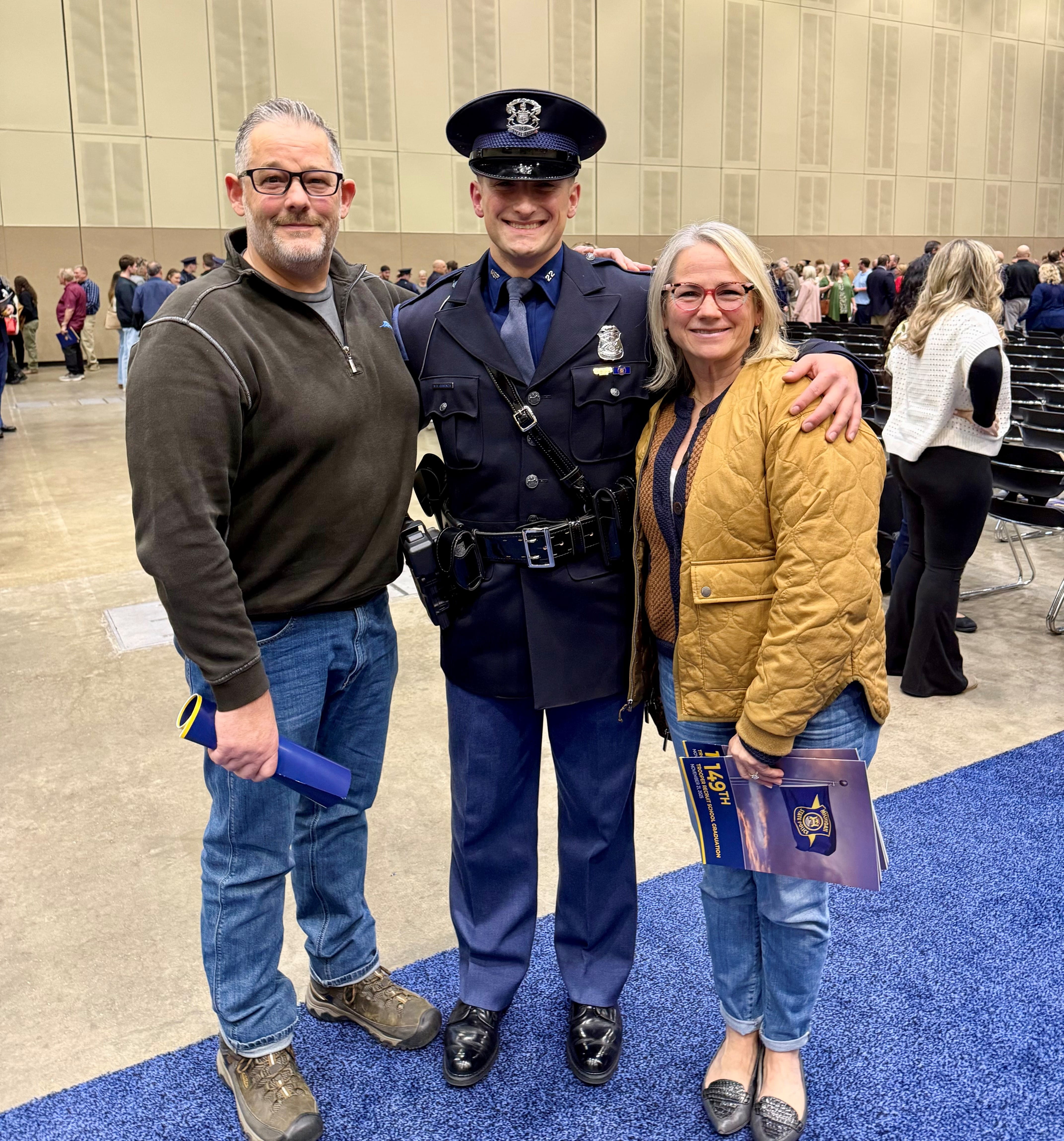 Dad and mom with new trooper following the 149th Trooper Recruit School graduation ceremony