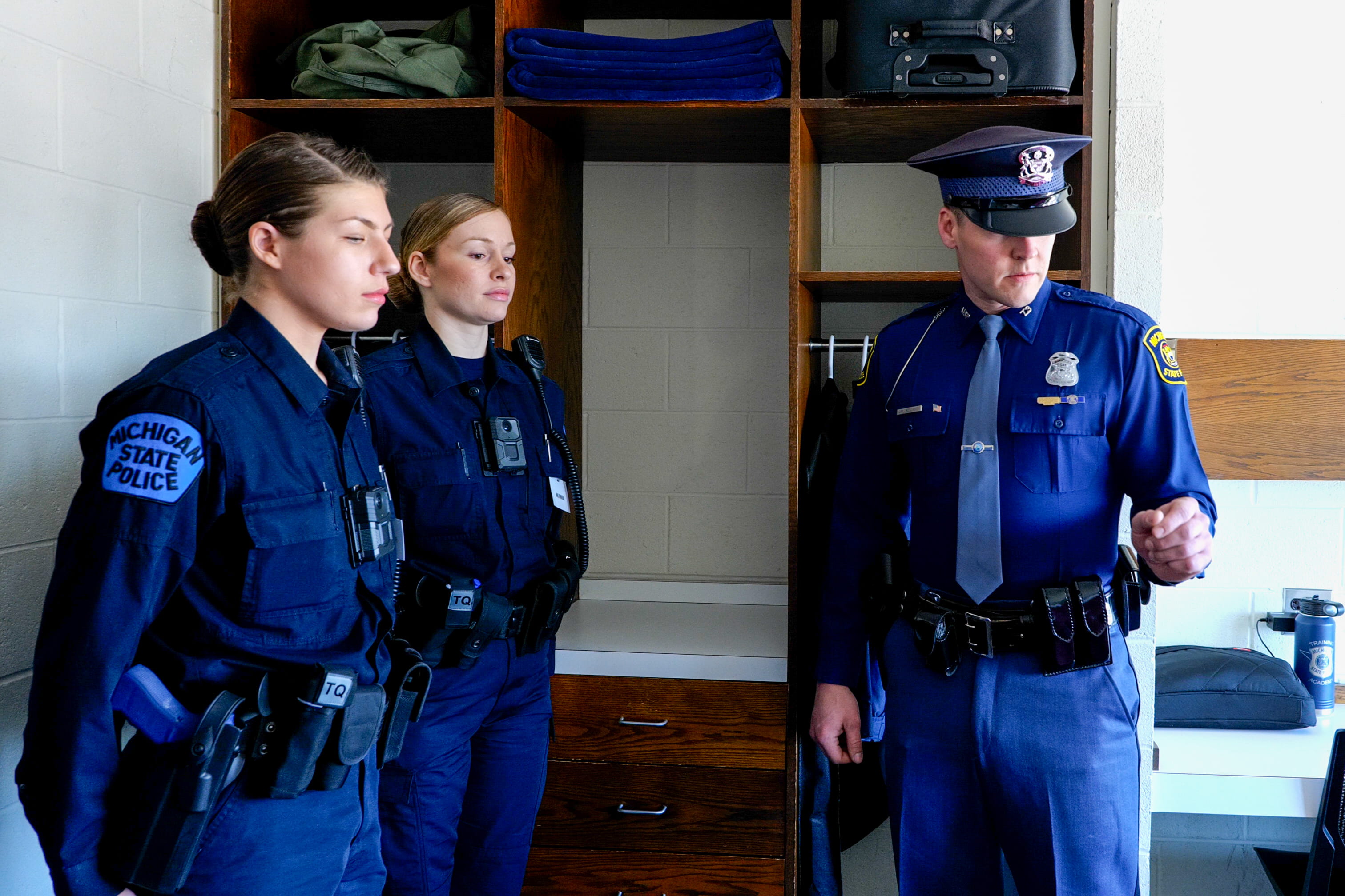 Photo of female recruits in room during inspection