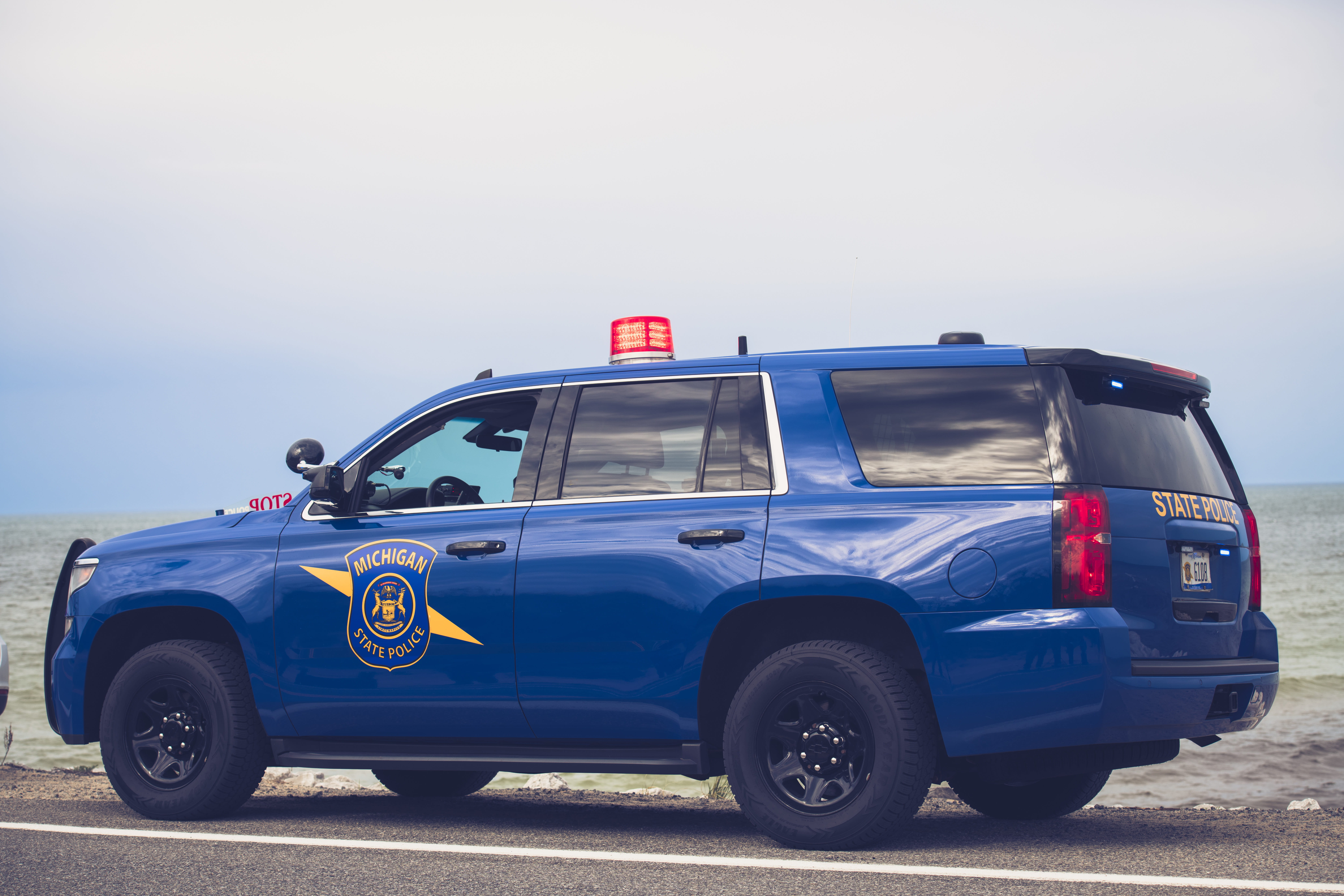 Michigan State Police patrol car parked near water.
