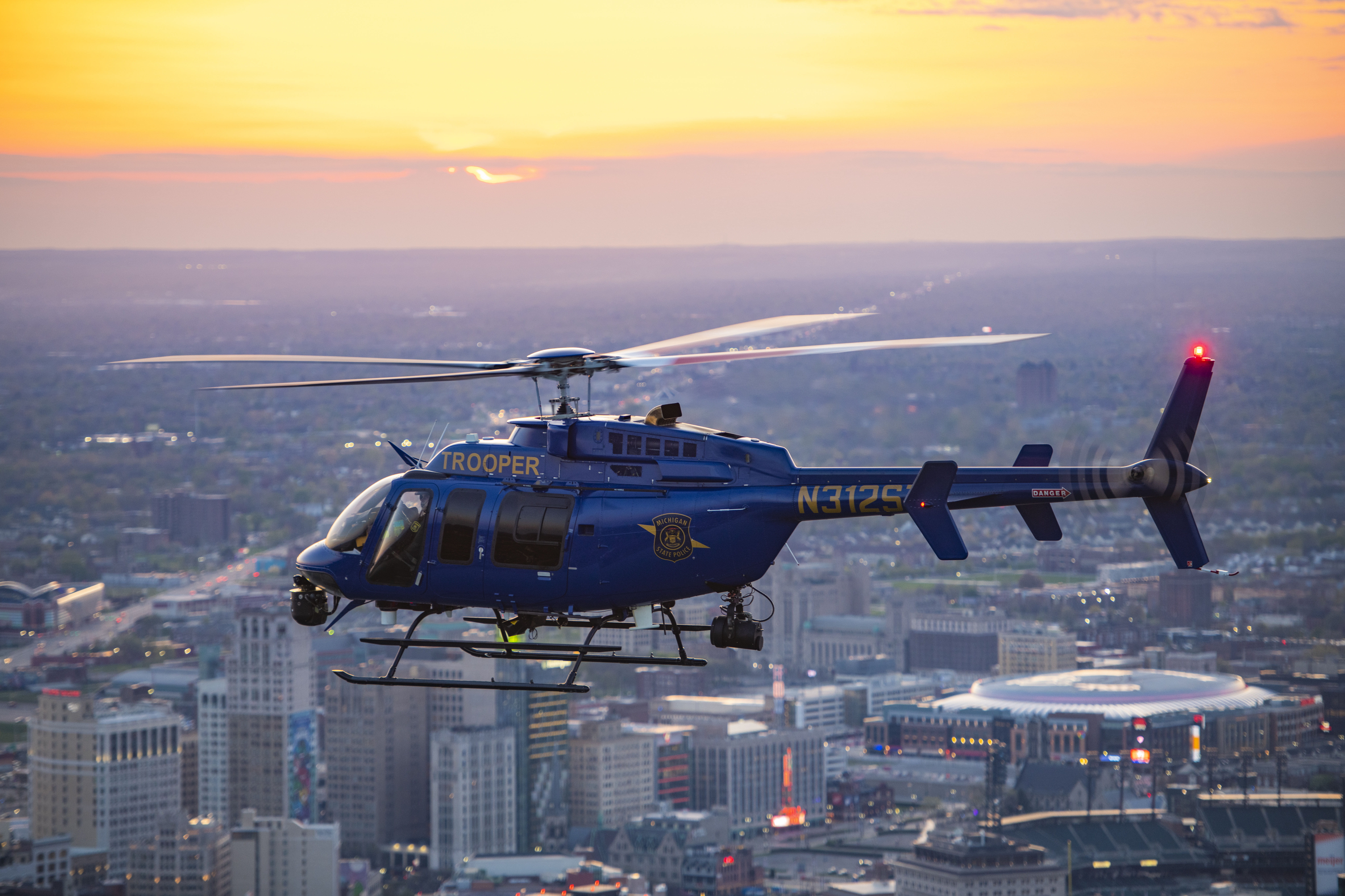 Michigan State Police helicopter flying over the city of Detroit. 