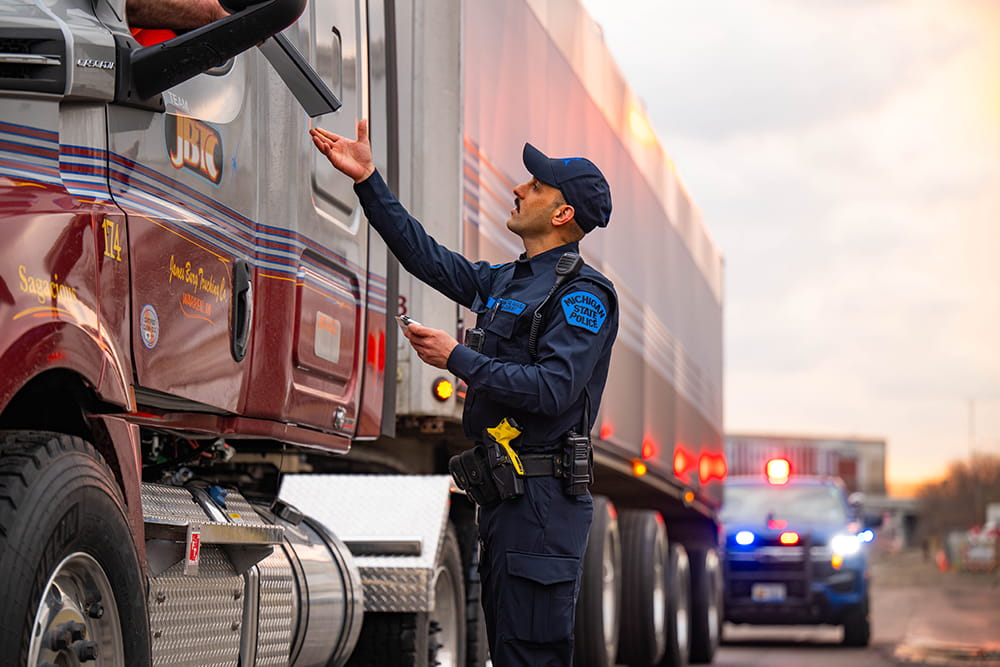 Motor Carrier Officer interacting with commercial vehicle driver on a traffic stop.