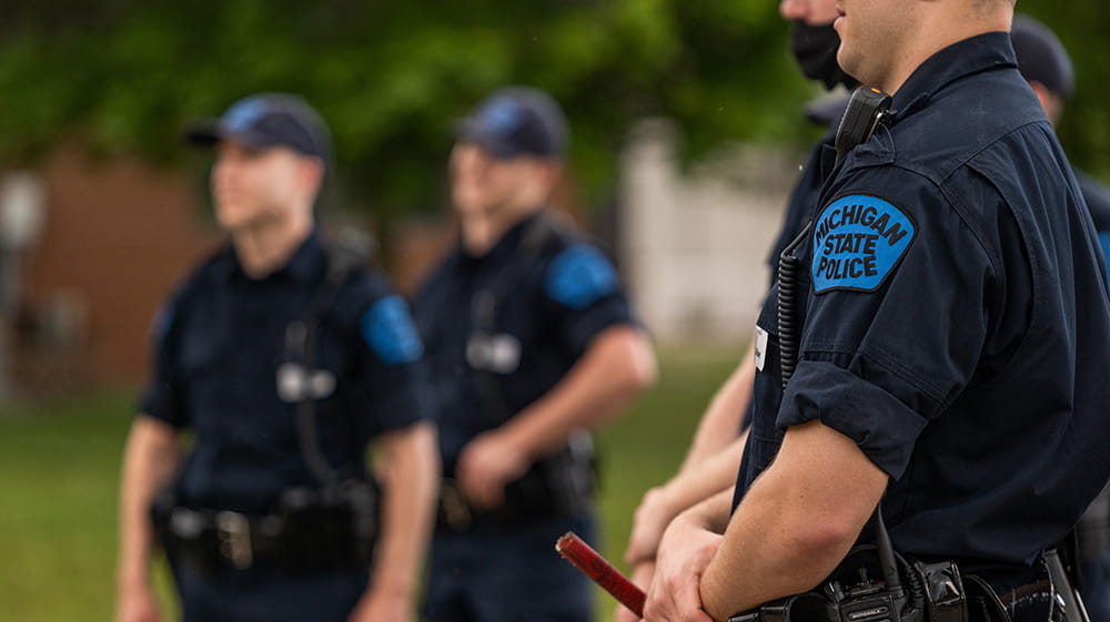 Several recruits standing outside Training Academy.