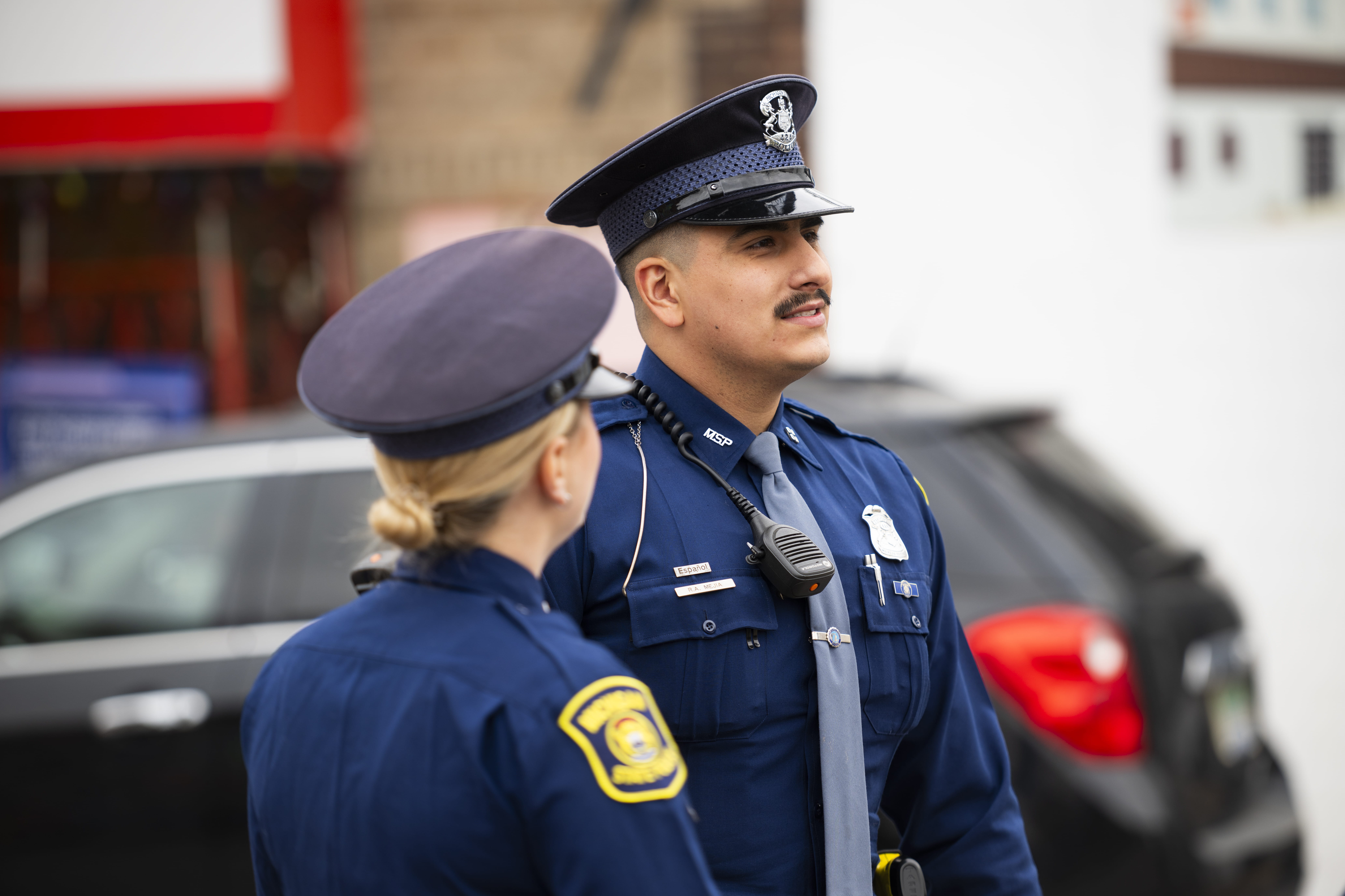 Male and female troopers interacting outdoors.