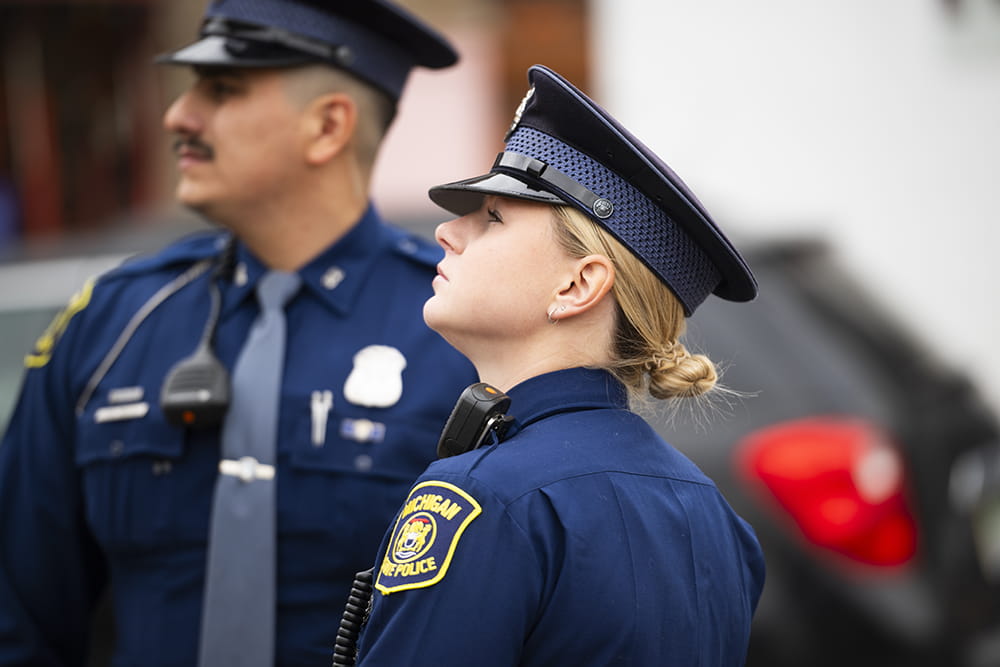 Male and female troopers interacting outdoors. 