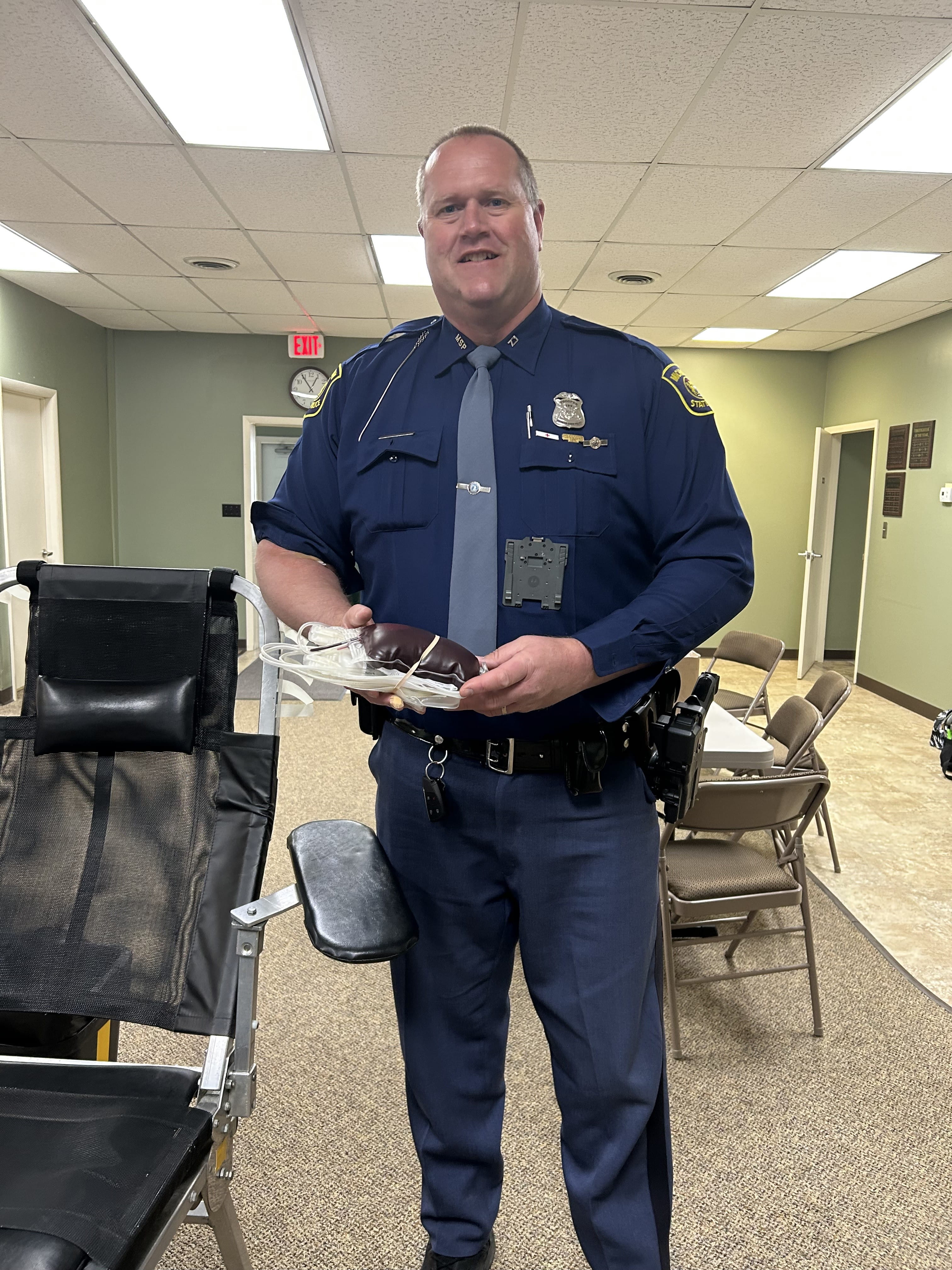 Trooper Skorka, assigned to the Cadillac Post, holding his blood donation