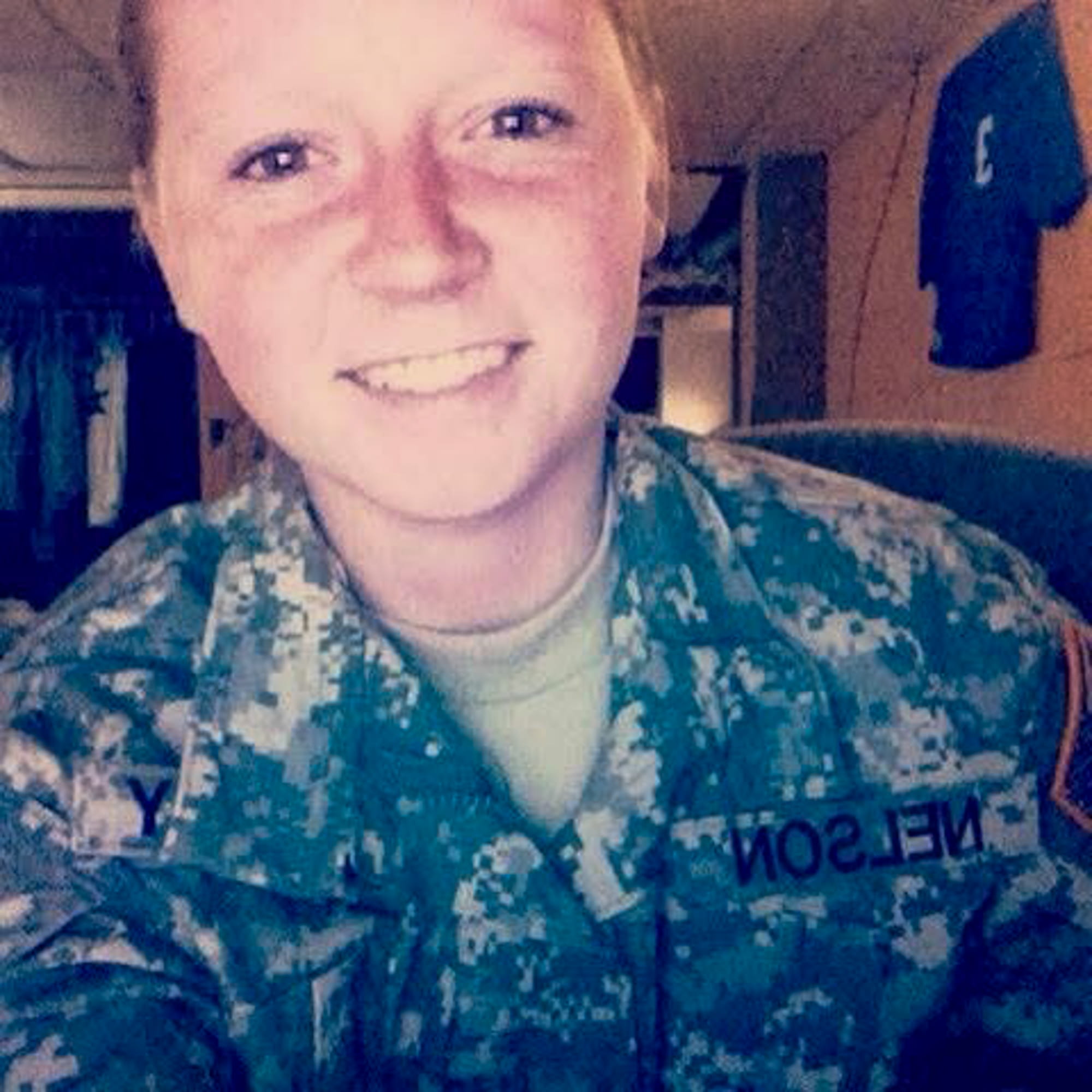 Alexis Nelson wearing National Guard uniform while posing for a photo