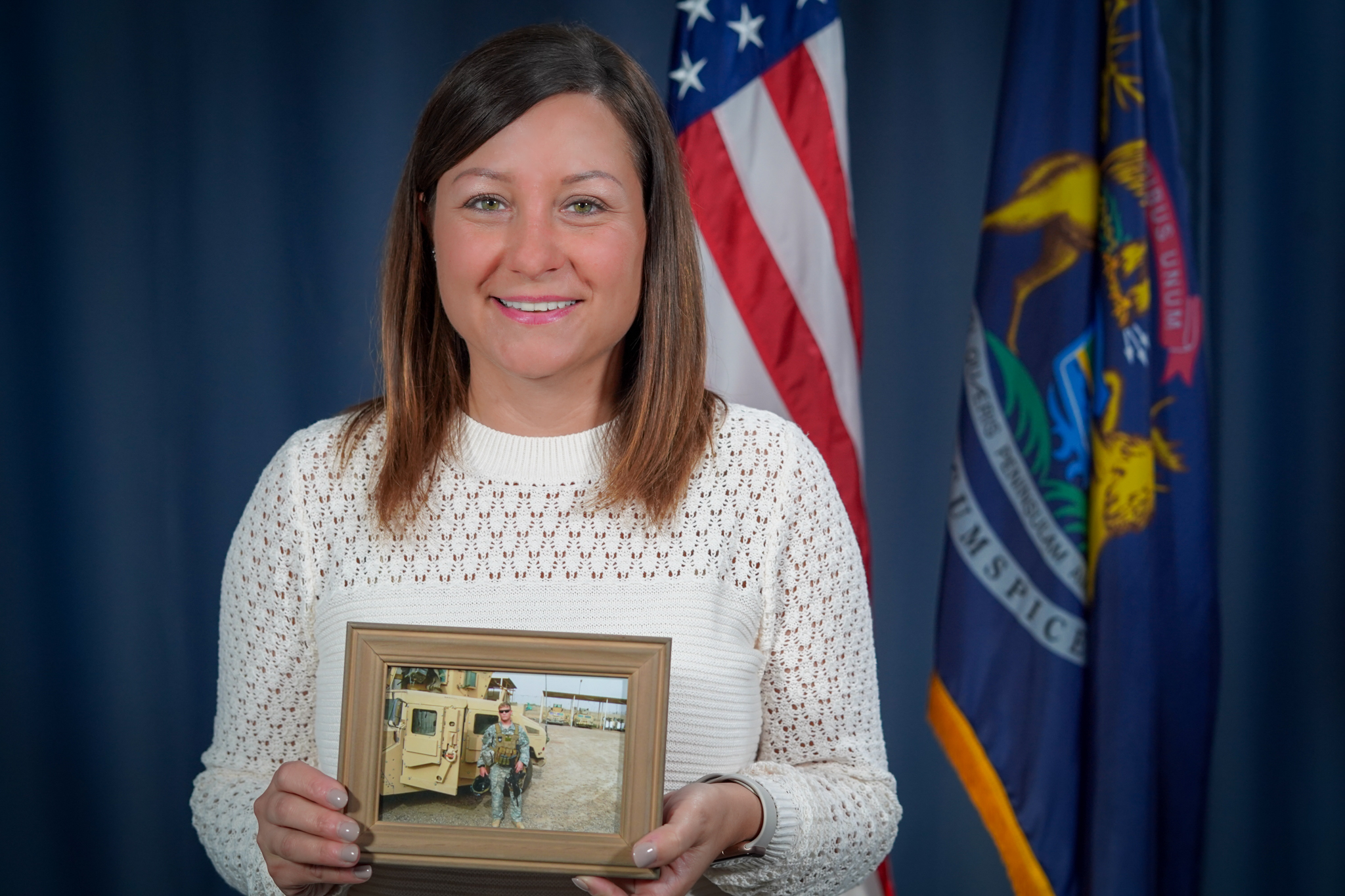 Kate Preston holding an image of her late husband