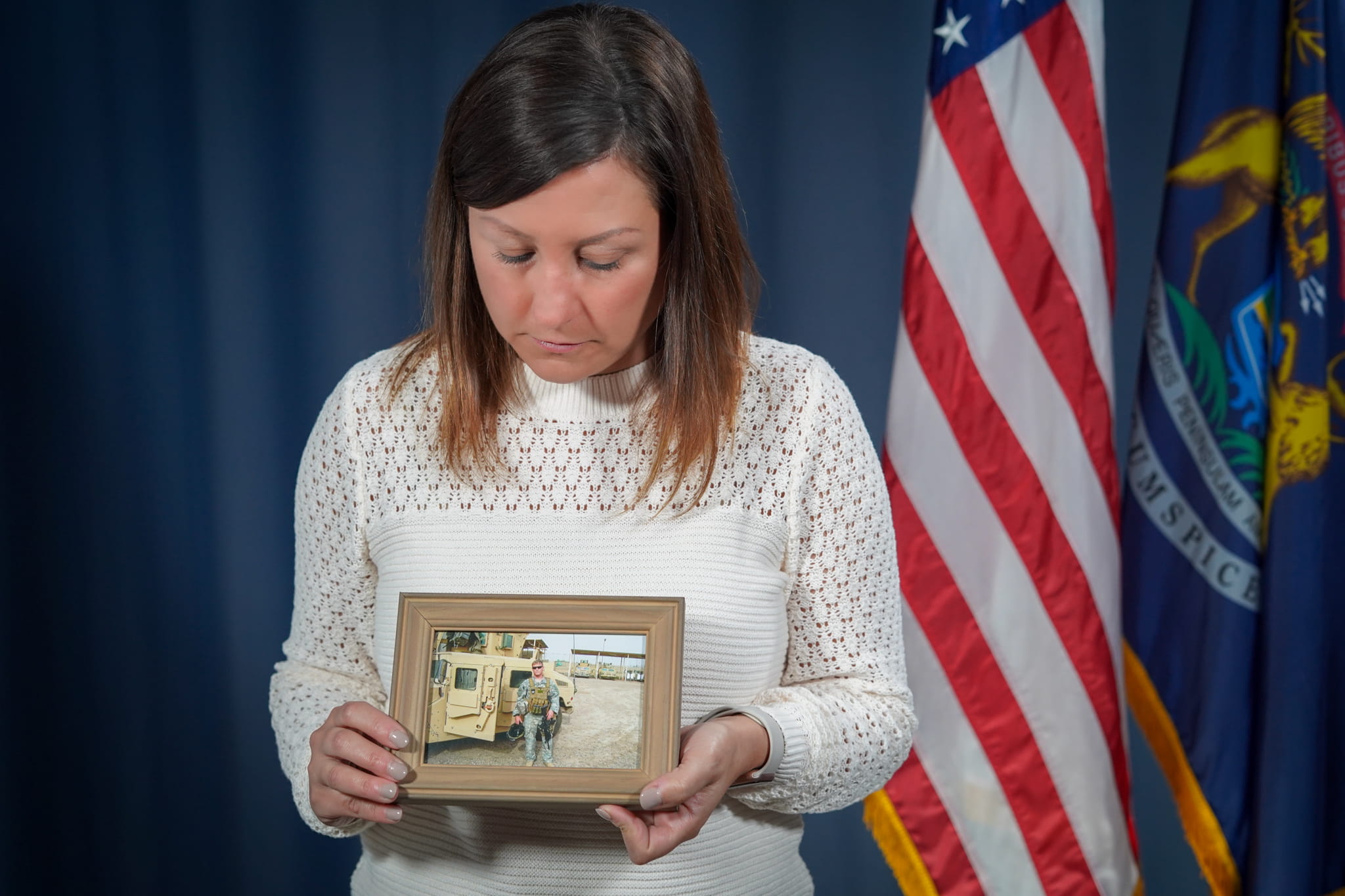 Kate Preston holding a photo of her late husband, Sgt. Darren Preston