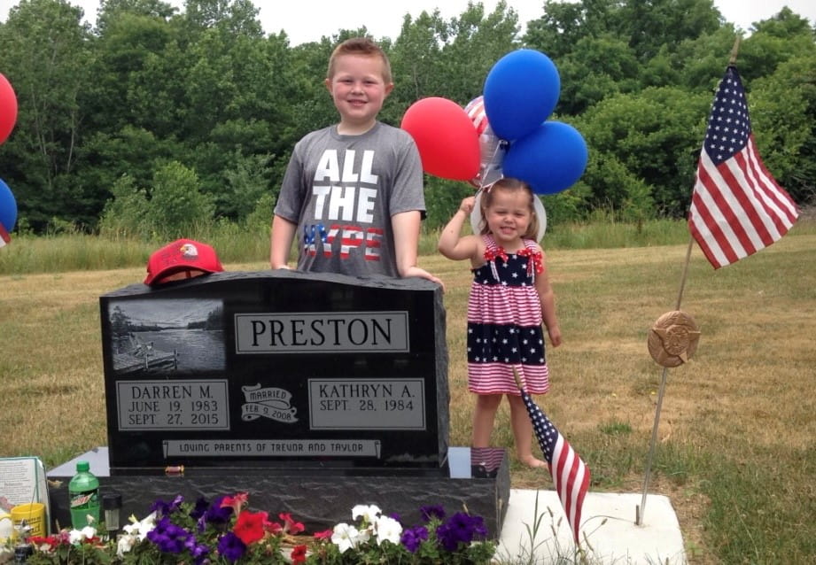 Kate Preston and children at her late husband's grave