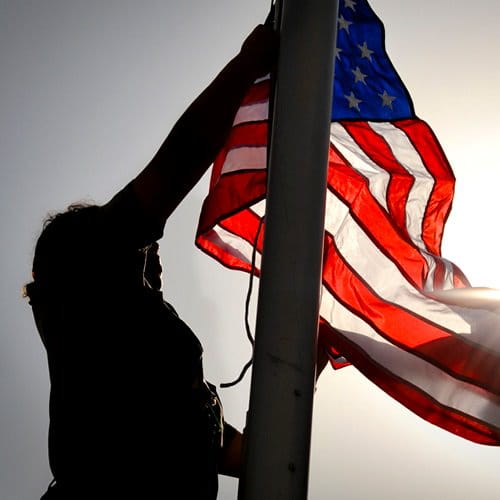 Person raising US flag