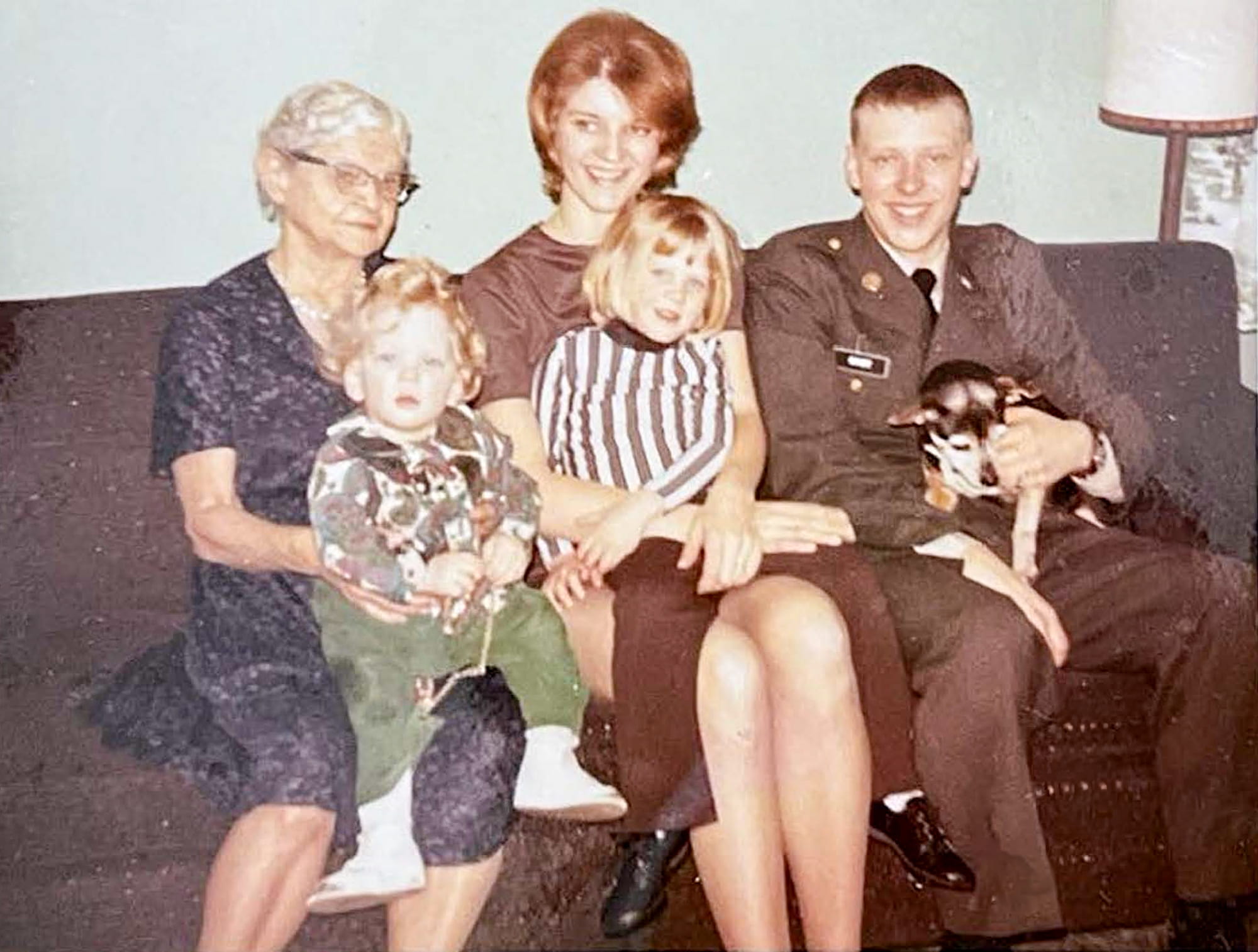 Don Doudt posing in uniform with family