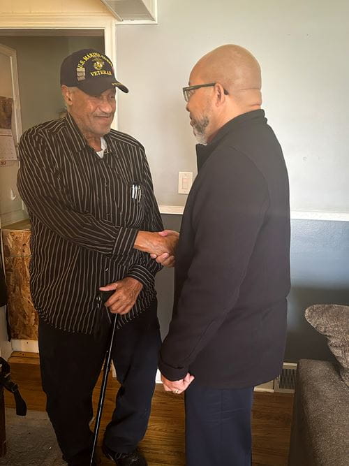 Lawrence Brooks (left) shakes hands with MVAA Director Brian L. Love