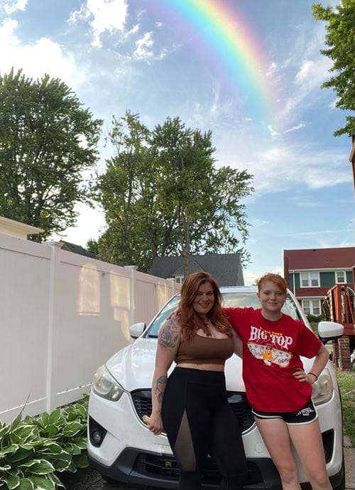 Chelsey Demick and her daughter in front of her vehicle