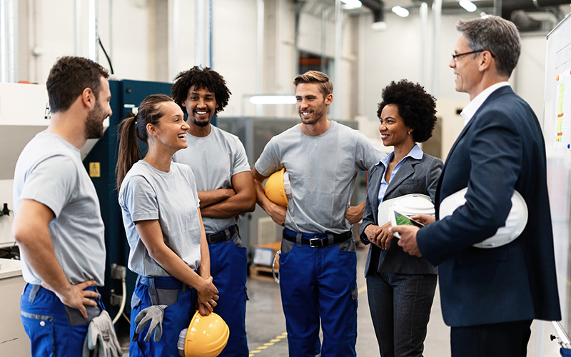 Group of workers talking with employer