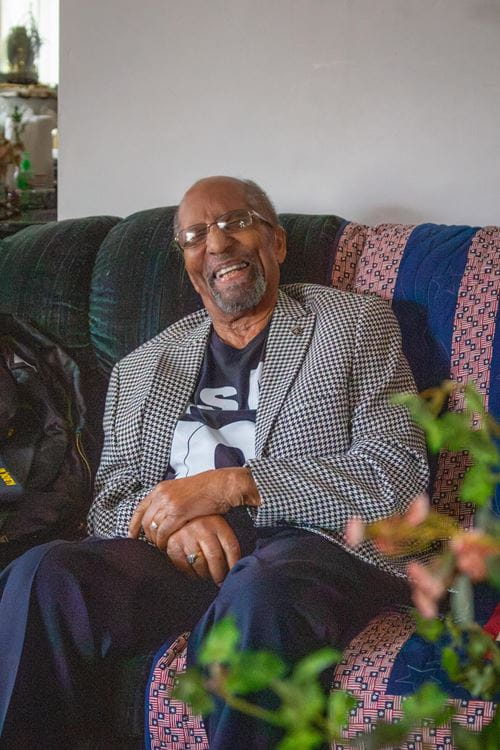Robert Holt, WWII veteran, laughs at his home in Albion.