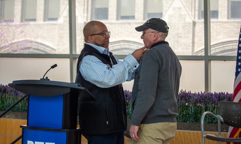 Director Brian L. Love with another individual on stage