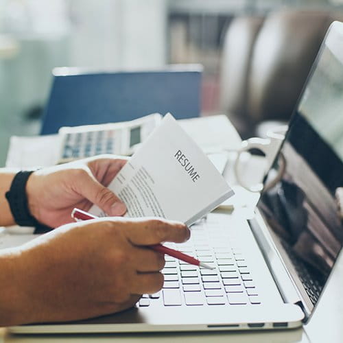 Person at computer reviewing documents