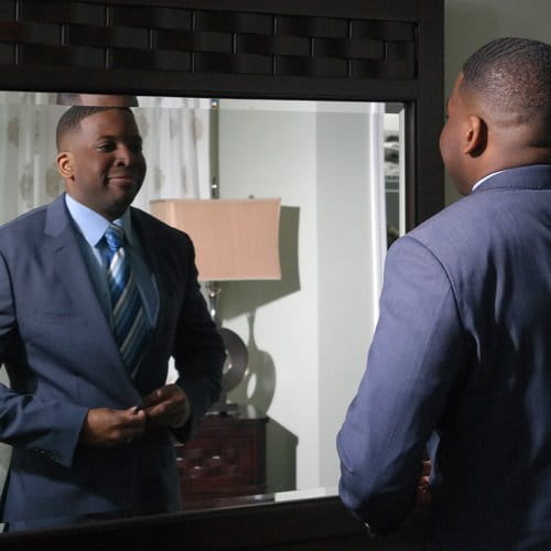 Man putting on suit