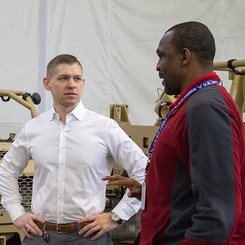 Two men touring work facility