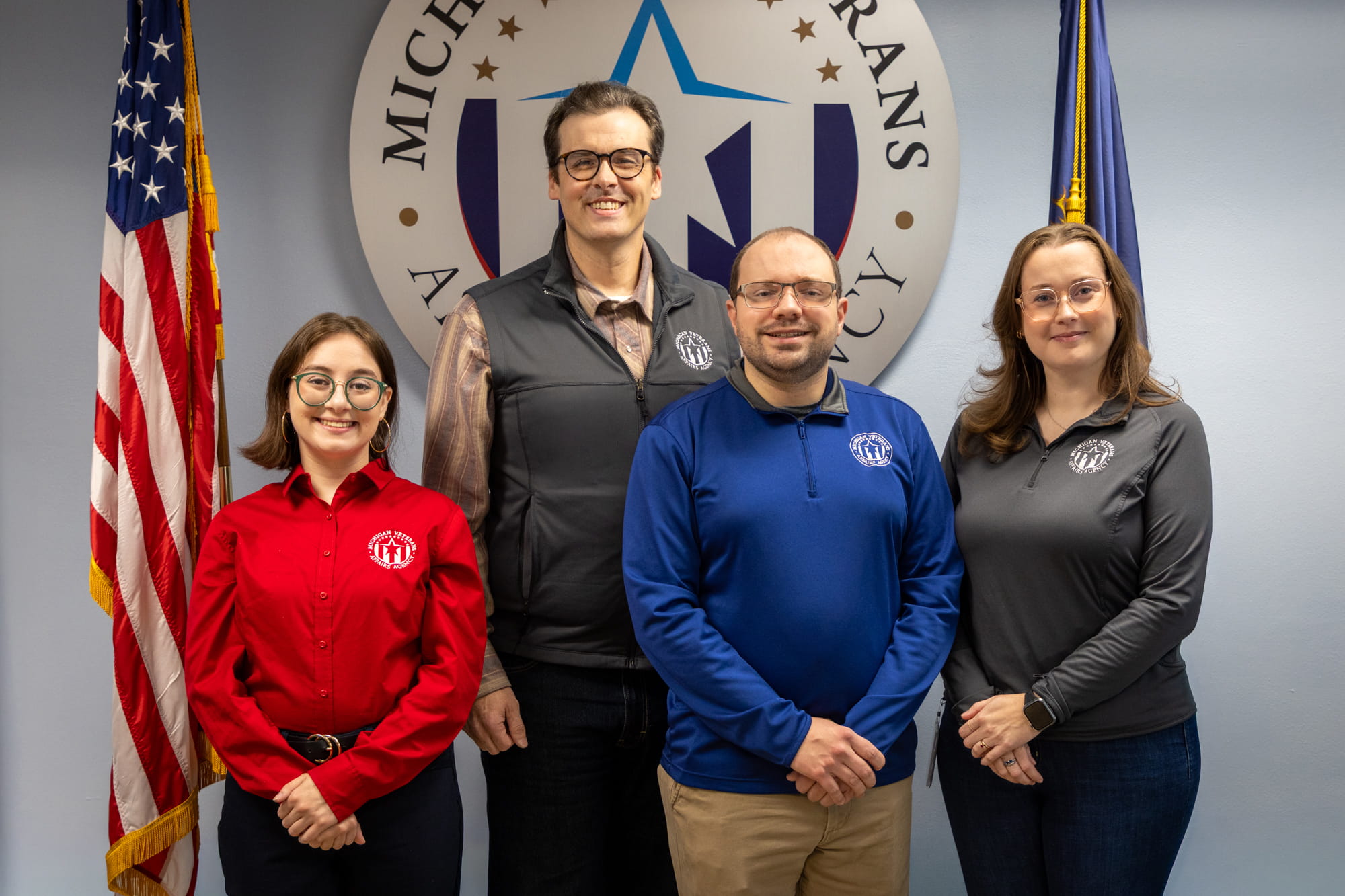 MVAA communications representative Isabella Gardner, strategic communications manager Zach Dillinger, visual content designer Andrew Robishaw and senior communications representative Natalie McCorvie pose in front of the MVAA logo