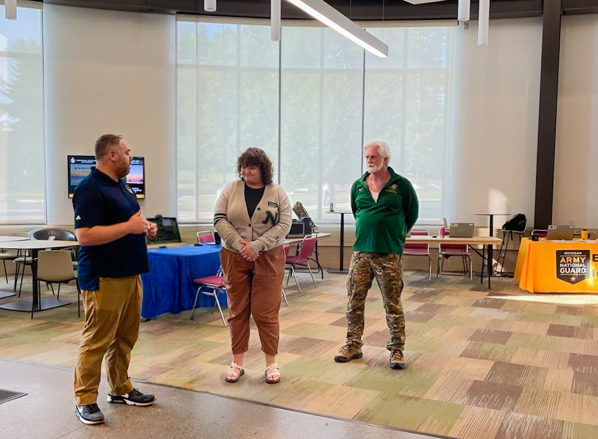 "Joe Saur, MVAA education analyst, presents the MVAA Coin of Excellence to Madi Spychalla, NMU Student Support Services Program assistant, with Mike Rutledge, NMU Veteran Services coordinator."