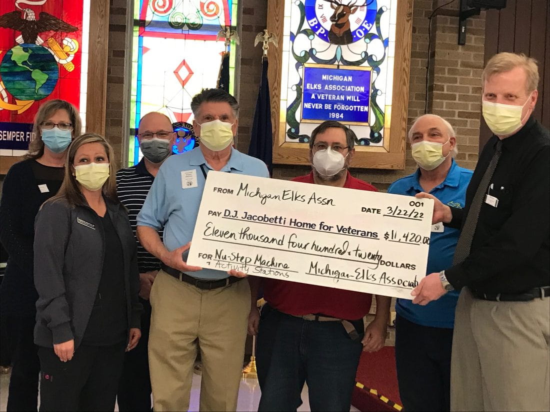 MVHGR staff and Michigan Elks Association member holds presentation check