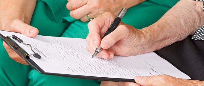 Veteran filling out a form to apply for benefits to live at Michigan Veteran Homes.