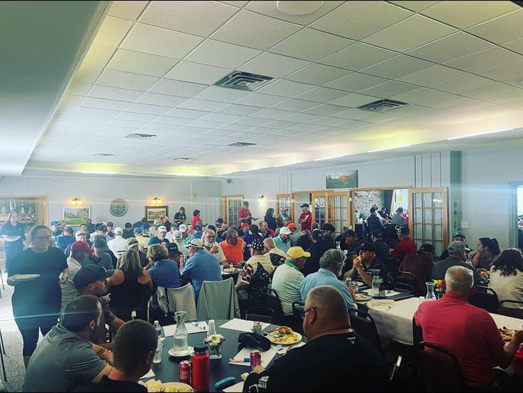 Award recipients stand on stage at the gala displaying their certificate