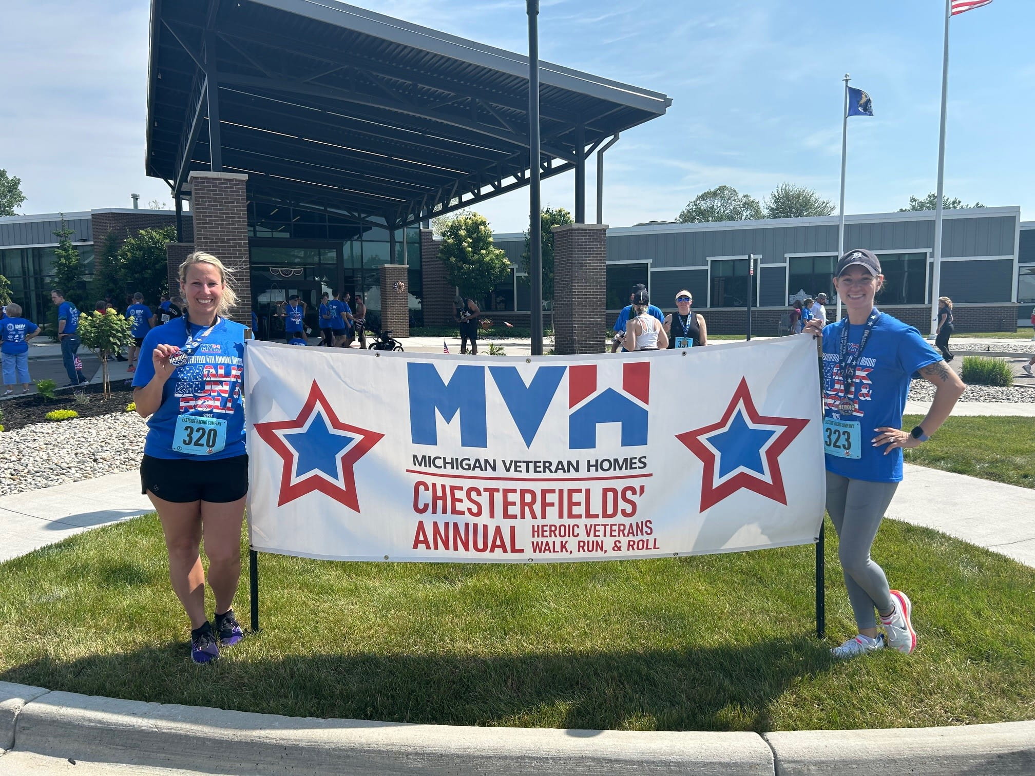 staff holding up banner for race