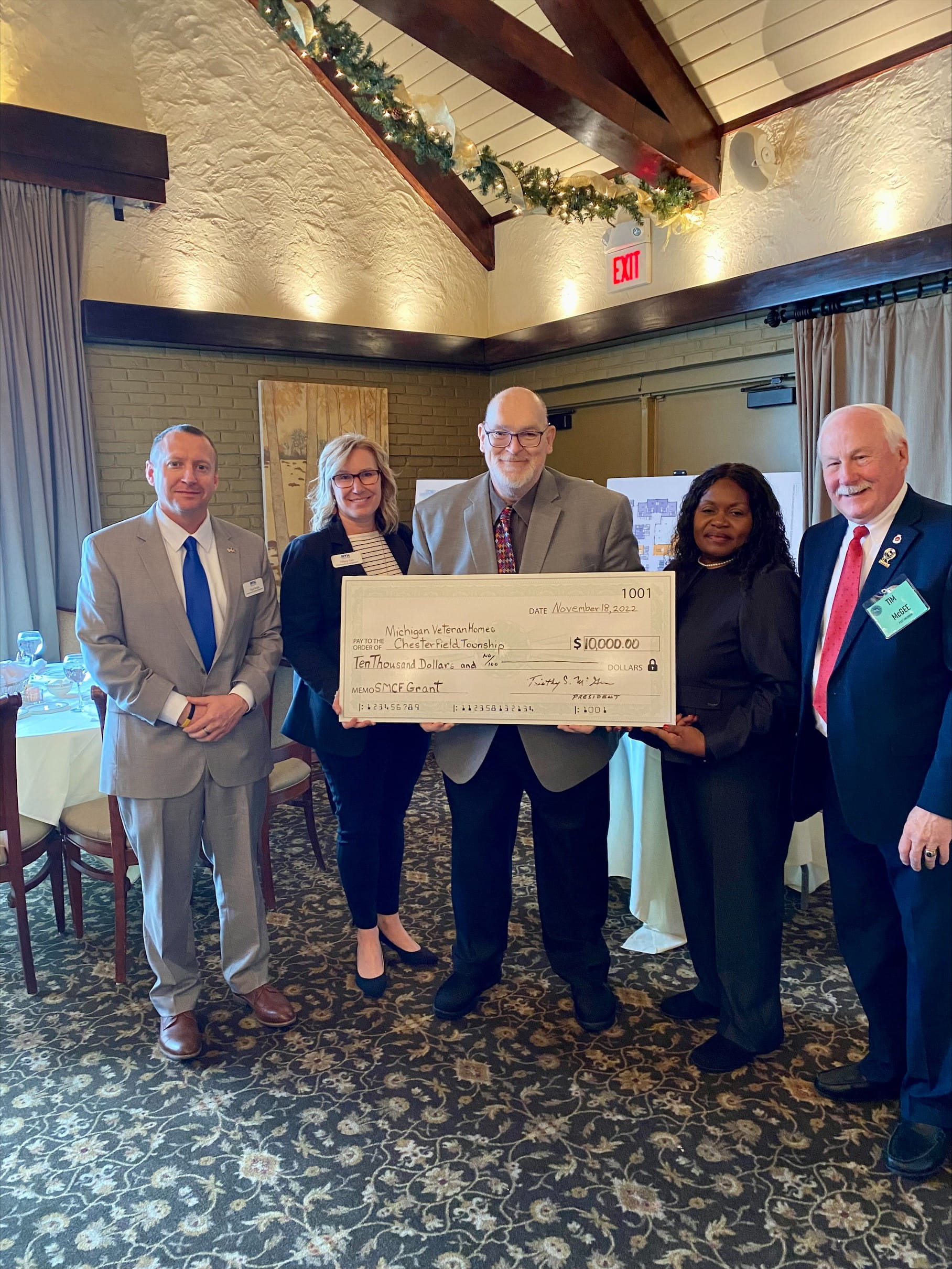 Award recipients stand on stage at the gala displaying their certificate