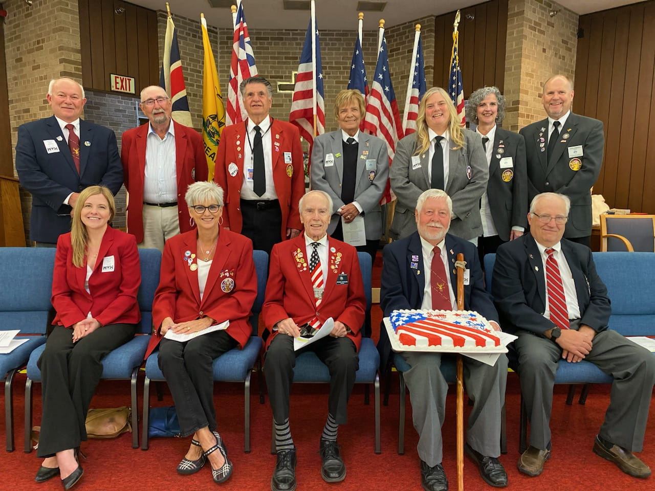Award recipients stand on stage at the gala displaying their certificate