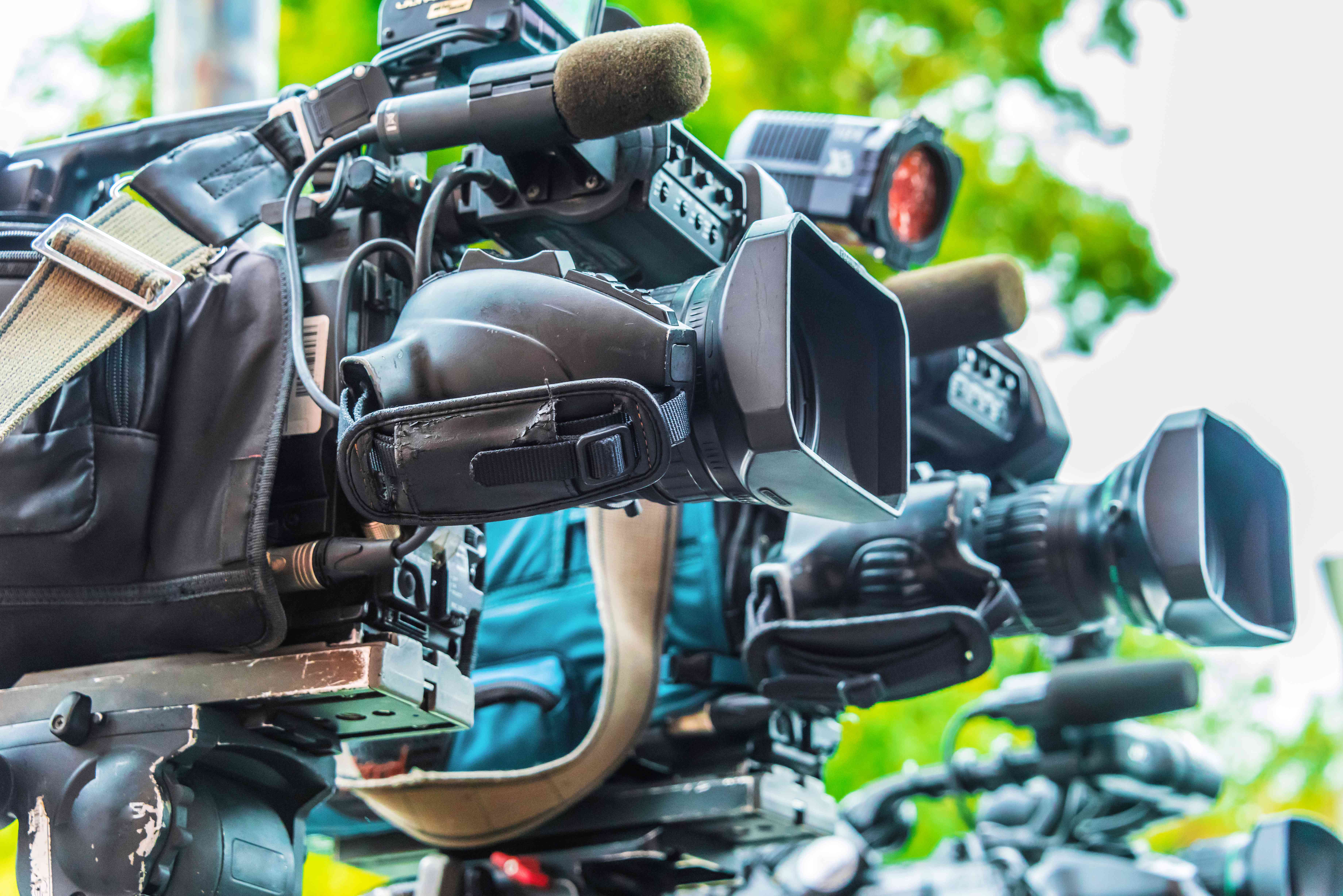 black video cameras sitting on tripods