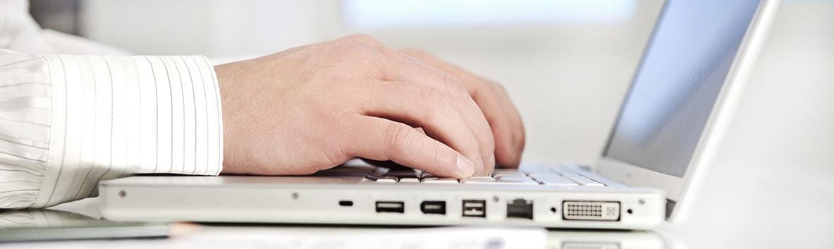 Veteran typing on a laptop.
