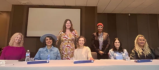 Flint menopause even panel sit at table with two standing behind those seated