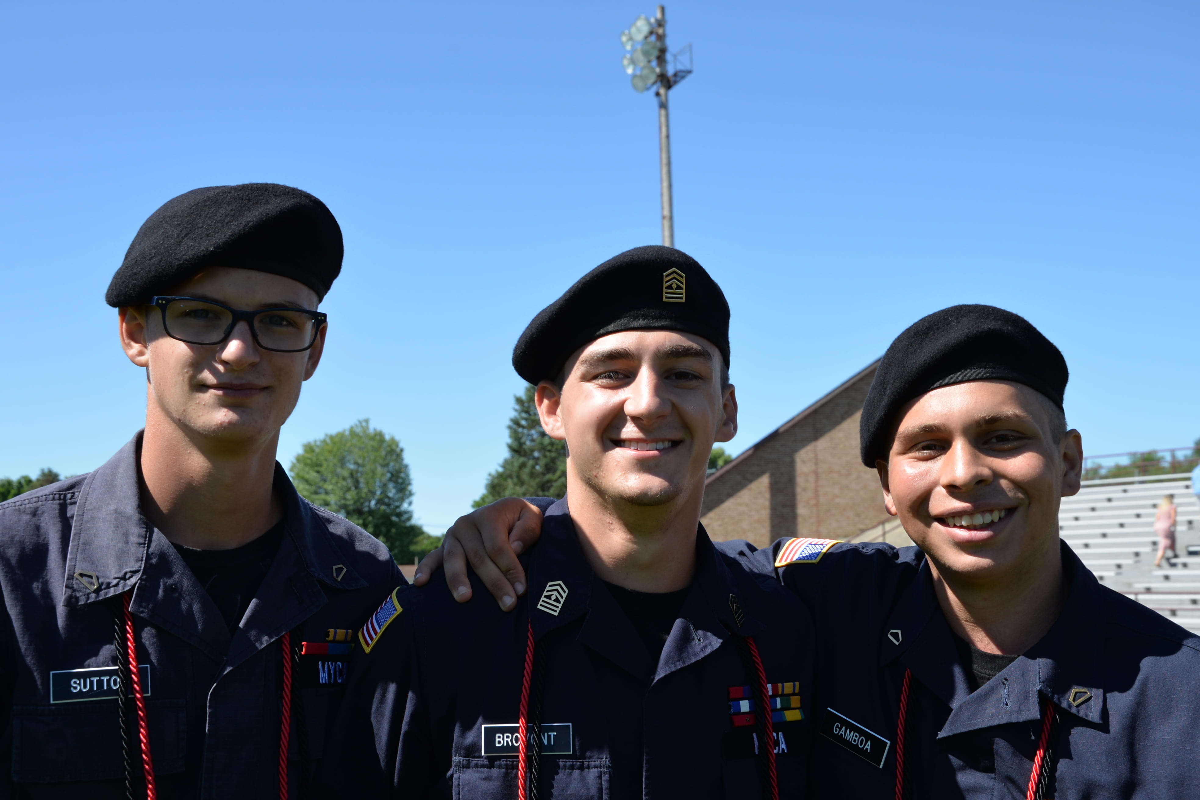3 male cadets smiling at graduation